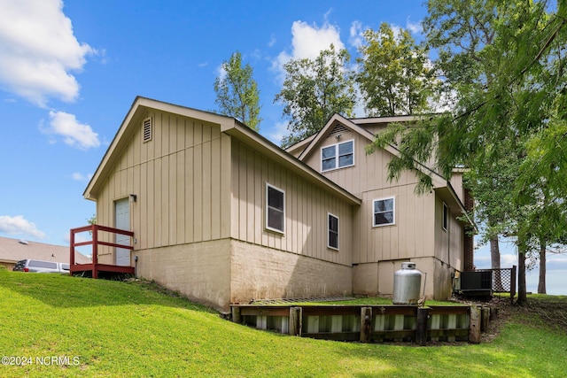 back of property with a yard and board and batten siding