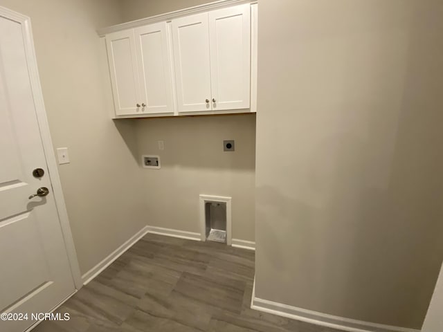 washroom with hookup for a washing machine, hookup for an electric dryer, baseboards, cabinet space, and dark wood-style floors