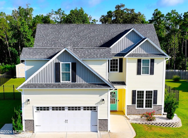 craftsman inspired home featuring a front yard and a garage