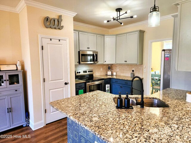 kitchen featuring dark hardwood / wood-style flooring, appliances with stainless steel finishes, a breakfast bar area, light stone countertops, and sink