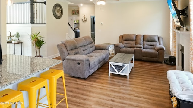 living room featuring crown molding, dark hardwood / wood-style flooring, and ceiling fan