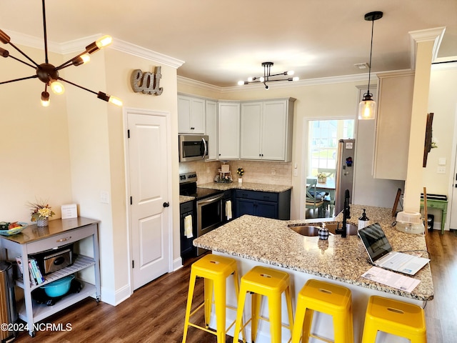 kitchen featuring appliances with stainless steel finishes, sink, ornamental molding, dark stone countertops, and decorative backsplash