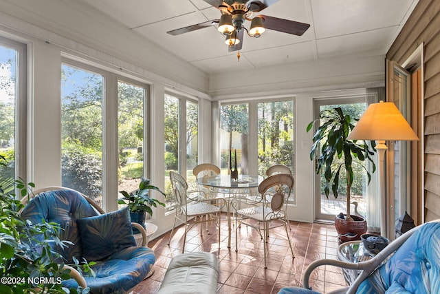 sunroom / solarium featuring ceiling fan and plenty of natural light