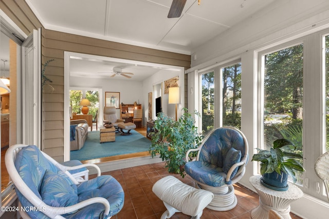 sunroom / solarium featuring ceiling fan