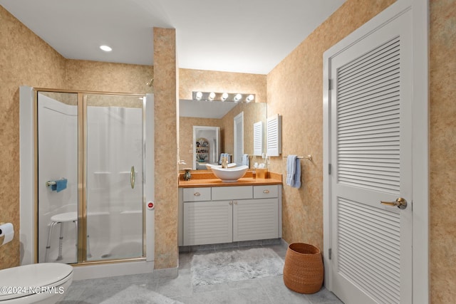 bathroom with an enclosed shower, vanity, and toilet