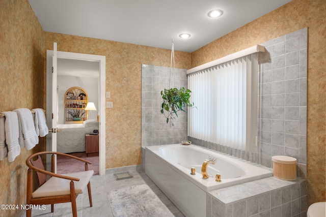 bathroom with tiled bath and tile patterned floors