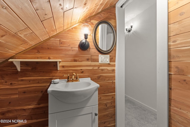 bathroom with wooden ceiling, wood walls, lofted ceiling, and vanity