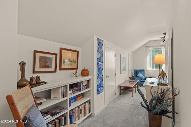 interior space featuring vaulted ceiling and light colored carpet