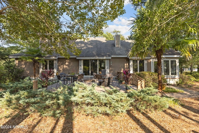 rear view of property featuring a patio area