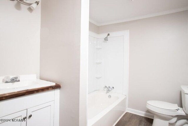 full bathroom with vanity, hardwood / wood-style floors, bathing tub / shower combination, crown molding, and toilet