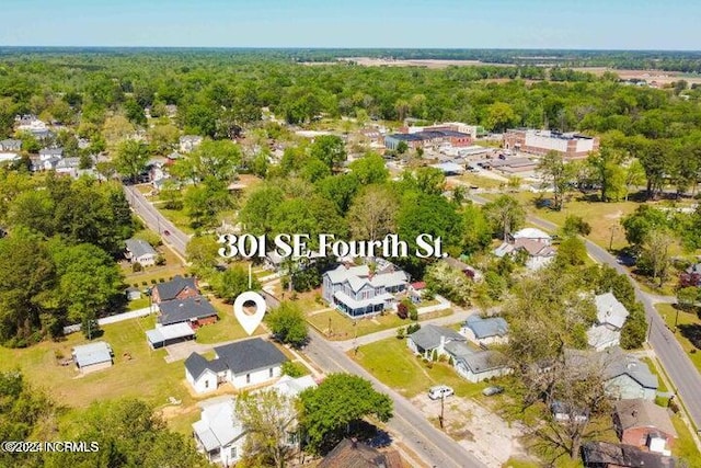 aerial view featuring a wooded view