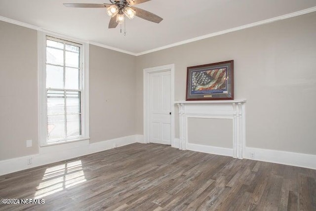 empty room featuring baseboards, ceiling fan, wood finished floors, and crown molding