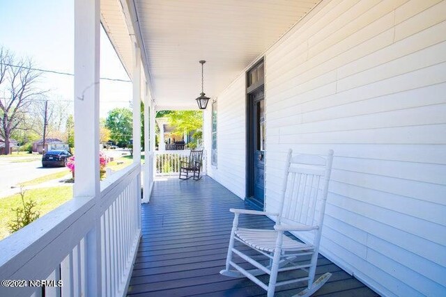 wooden terrace featuring covered porch