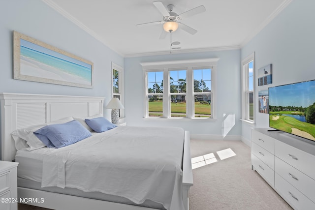 bedroom featuring a ceiling fan, baseboards, crown molding, and light colored carpet