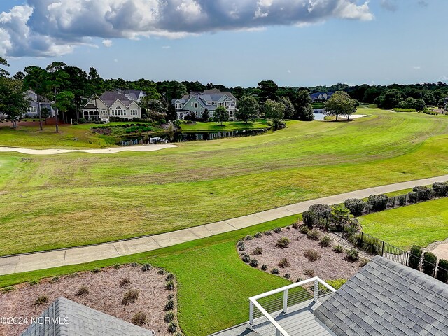 view of community with a water view and a lawn