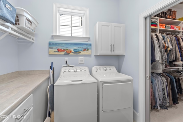 laundry area featuring cabinet space, carpet, and washer and dryer