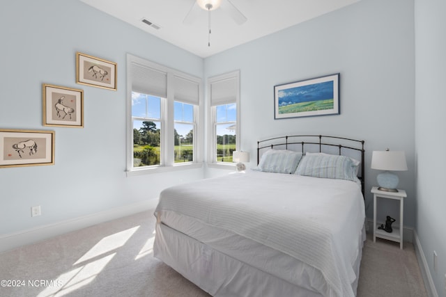 bedroom featuring carpet floors, a ceiling fan, visible vents, and baseboards