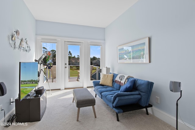 living area featuring carpet and baseboards