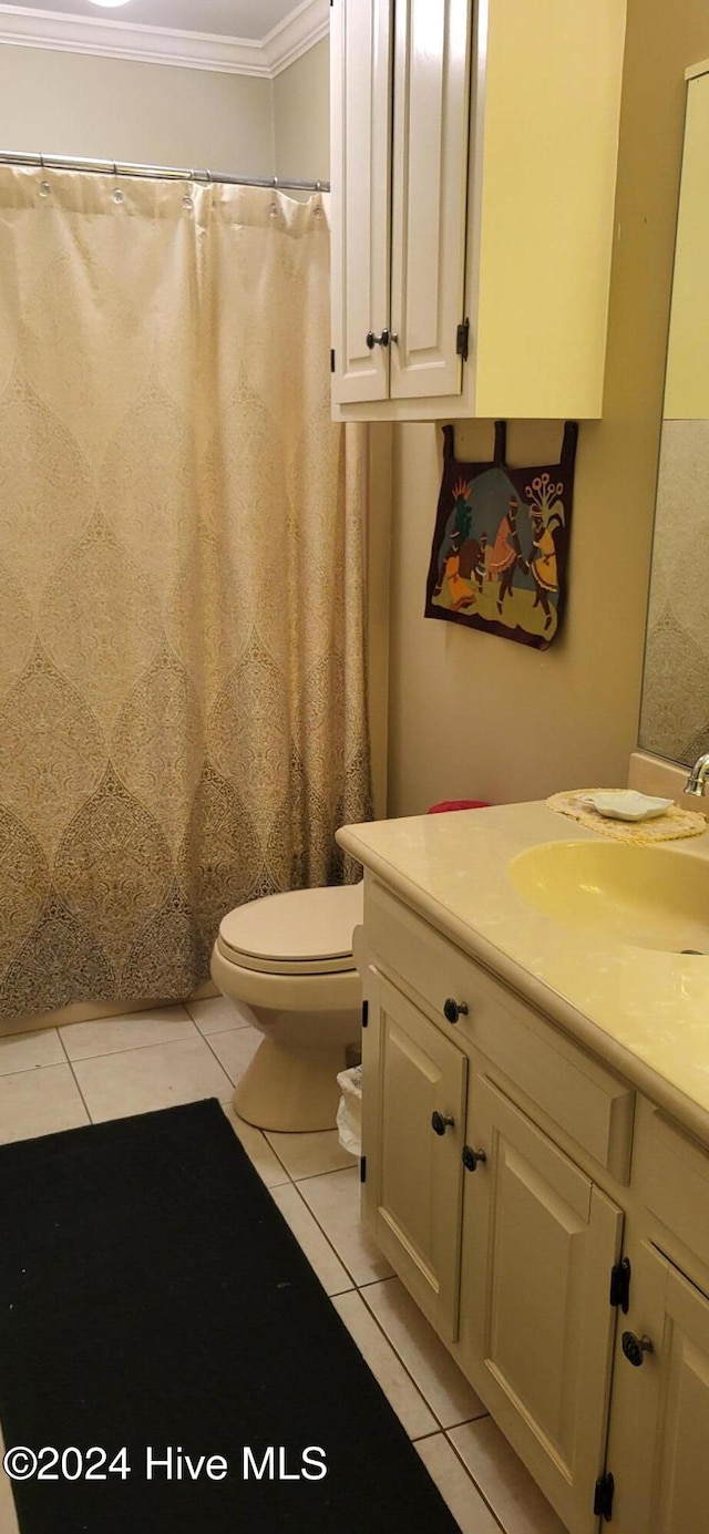 full bathroom featuring toilet, tile patterned flooring, crown molding, and vanity