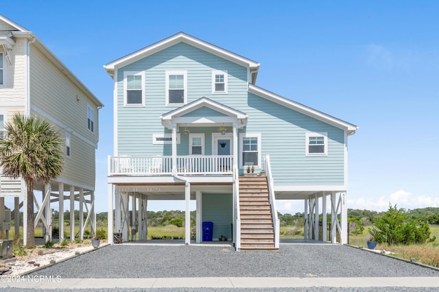 coastal home featuring a porch and a carport