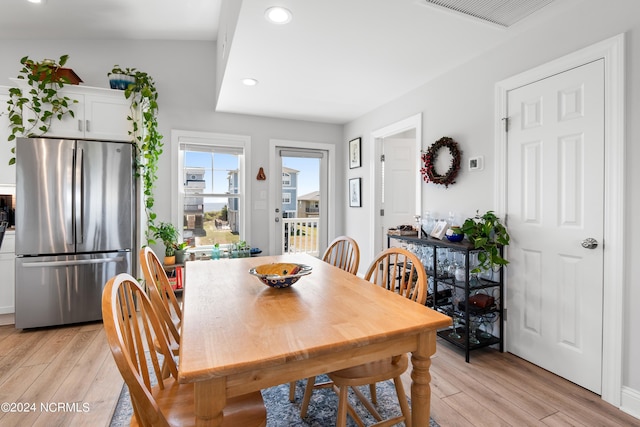 dining area featuring light wood finished floors, visible vents, and recessed lighting