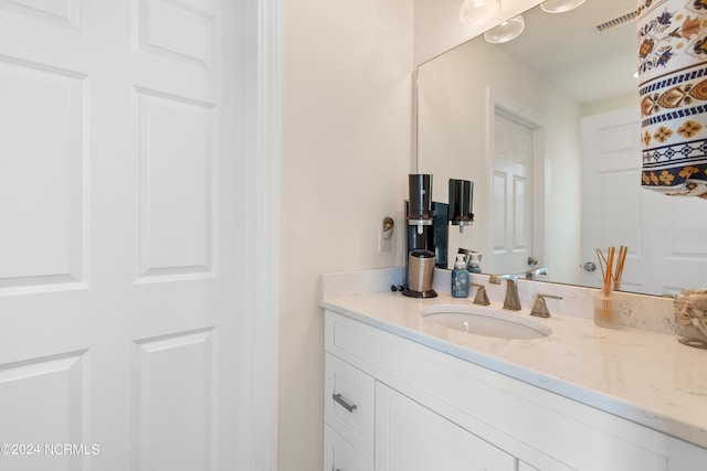 bathroom featuring visible vents and vanity