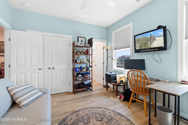 home office with a ceiling fan and light wood-style floors