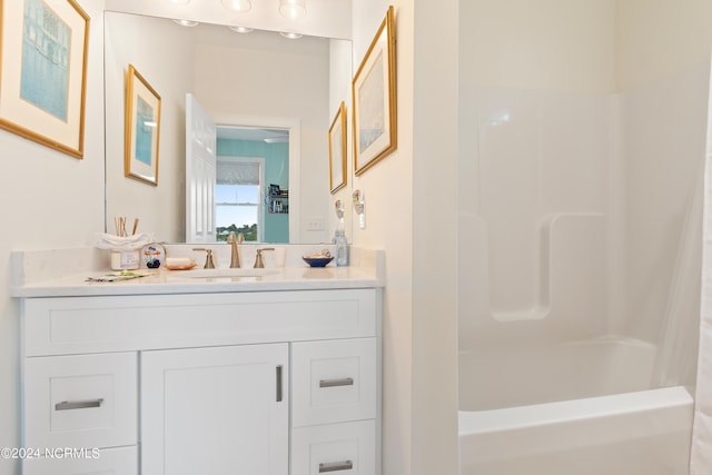 bathroom featuring shower / bath combo and vanity