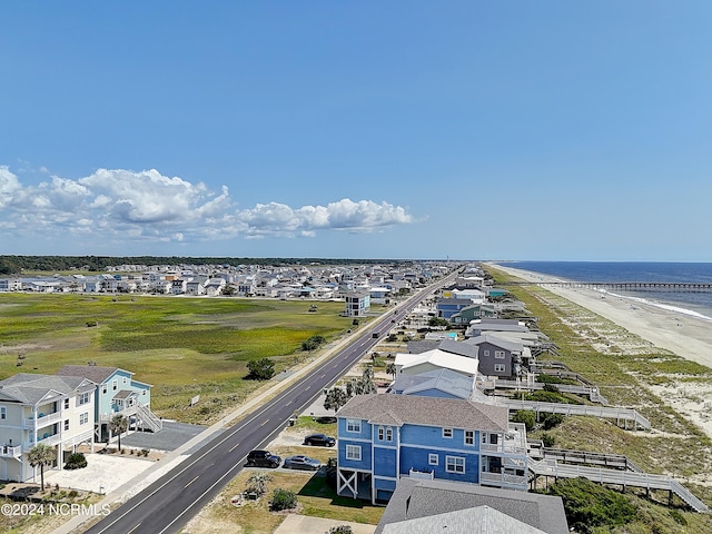 birds eye view of property with a water view and a view of the beach