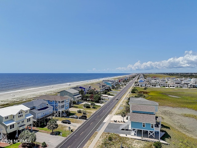 bird's eye view with a water view and a beach view