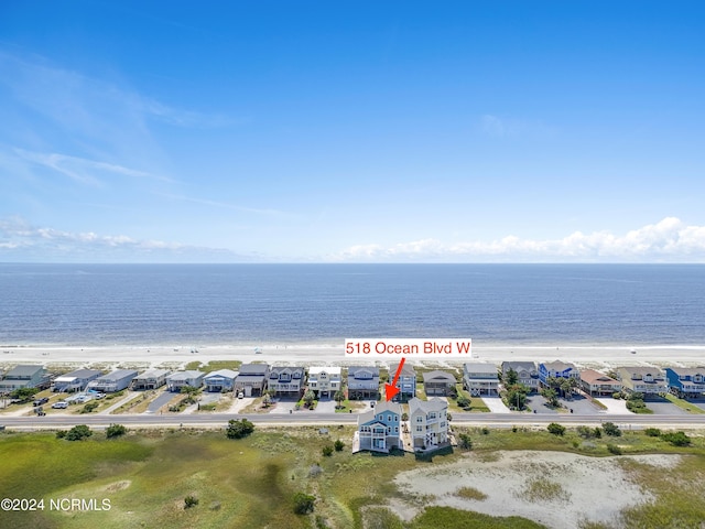 birds eye view of property featuring a water view and a view of the beach