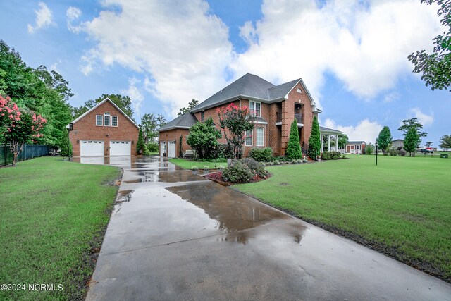 view of front of property featuring a garage and a front lawn