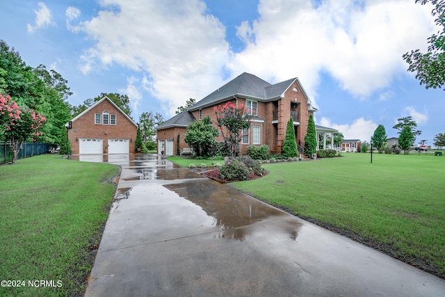 traditional-style home with a garage, driveway, brick siding, fence, and a front yard