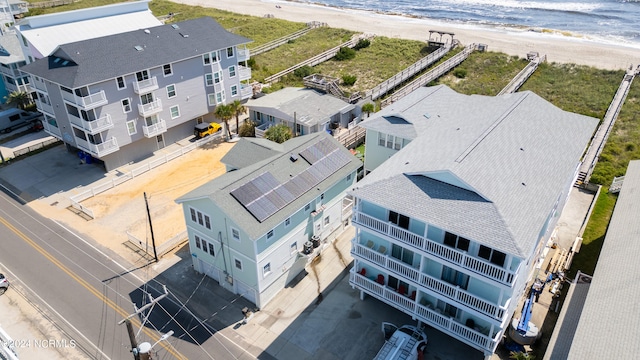 drone / aerial view with a water view and a view of the beach