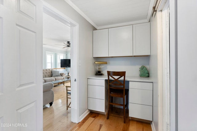 interior space with ceiling fan, crown molding, and light hardwood / wood-style flooring