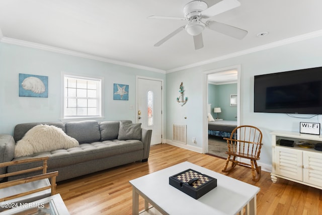 living room featuring crown molding, light hardwood / wood-style flooring, and ceiling fan