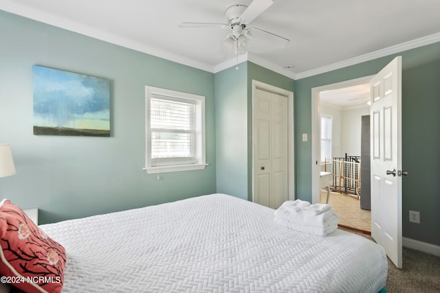 bedroom with ceiling fan, ornamental molding, a closet, and light tile patterned flooring