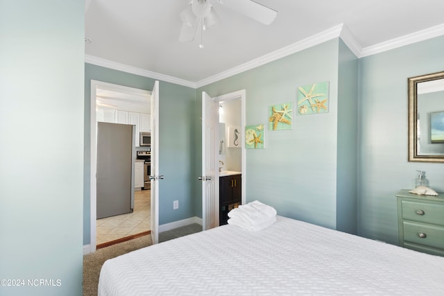 tiled bedroom with ceiling fan, ornamental molding, and ensuite bath