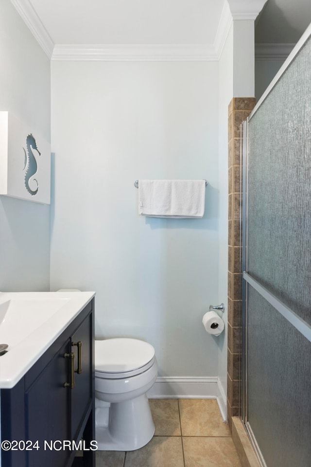 bathroom featuring toilet, walk in shower, tile patterned flooring, crown molding, and vanity