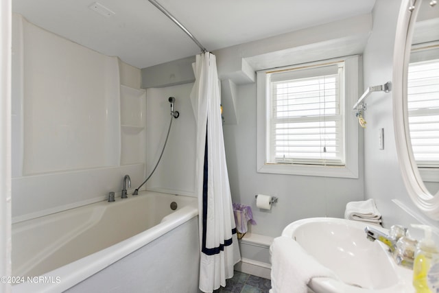 bathroom featuring tile patterned flooring, shower / bath combo with shower curtain, and toilet