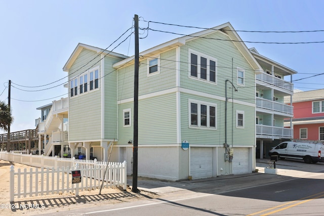 view of side of home with a balcony and a garage