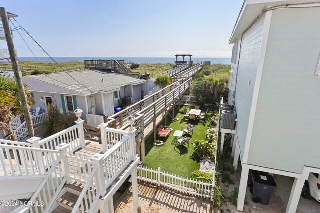 exterior space with a water view and central AC unit