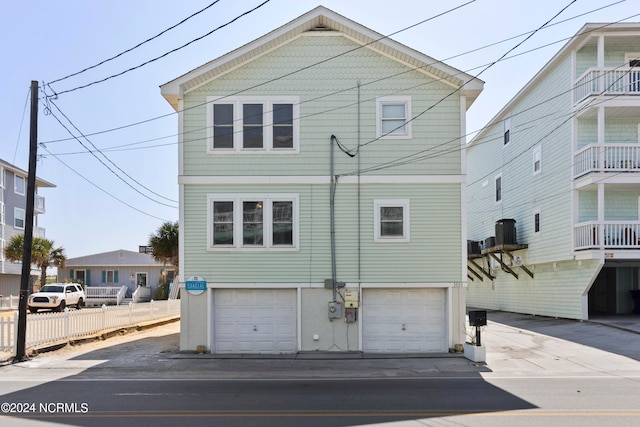 view of property featuring a garage and a balcony