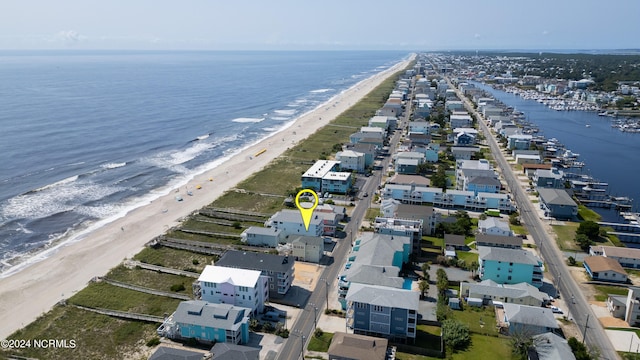 birds eye view of property featuring a beach view and a water view