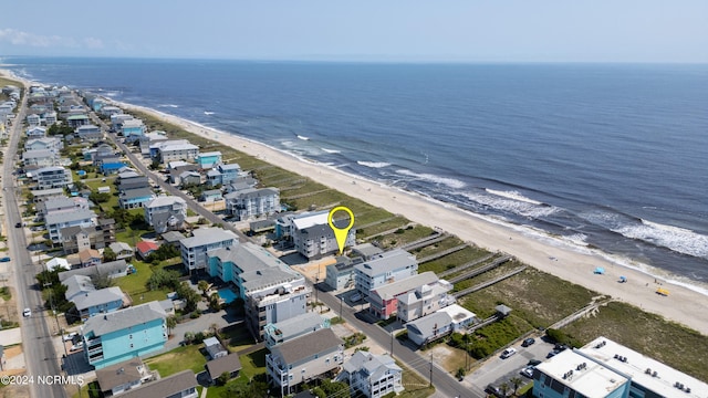 birds eye view of property with a beach view and a water view