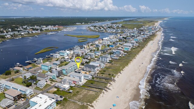 drone / aerial view with a water view and a beach view