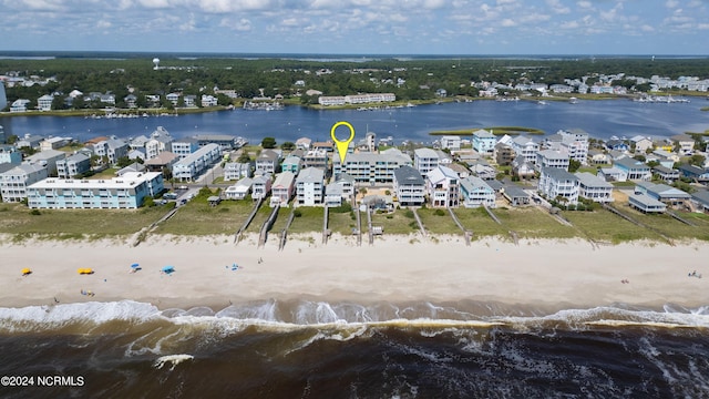 birds eye view of property with a water view and a view of the beach