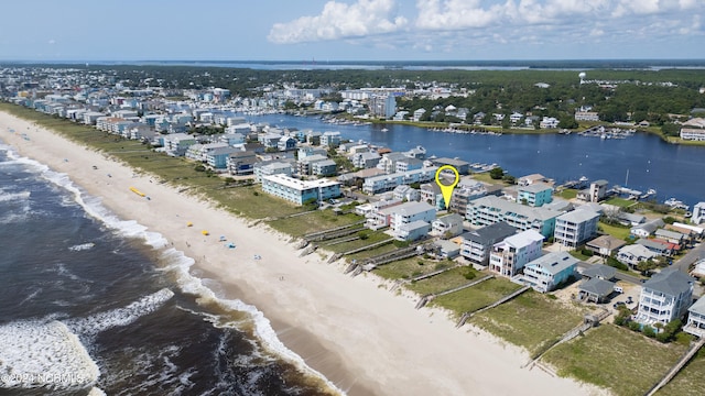 drone / aerial view featuring a beach view and a water view