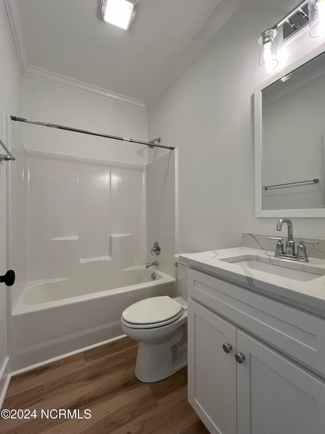 full bathroom featuring wood-type flooring, toilet, shower / tub combination, vanity, and crown molding