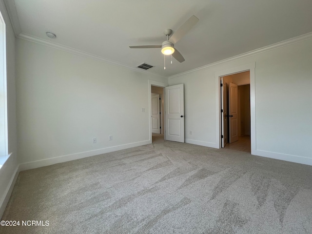 unfurnished bedroom featuring ceiling fan, ornamental molding, and light colored carpet